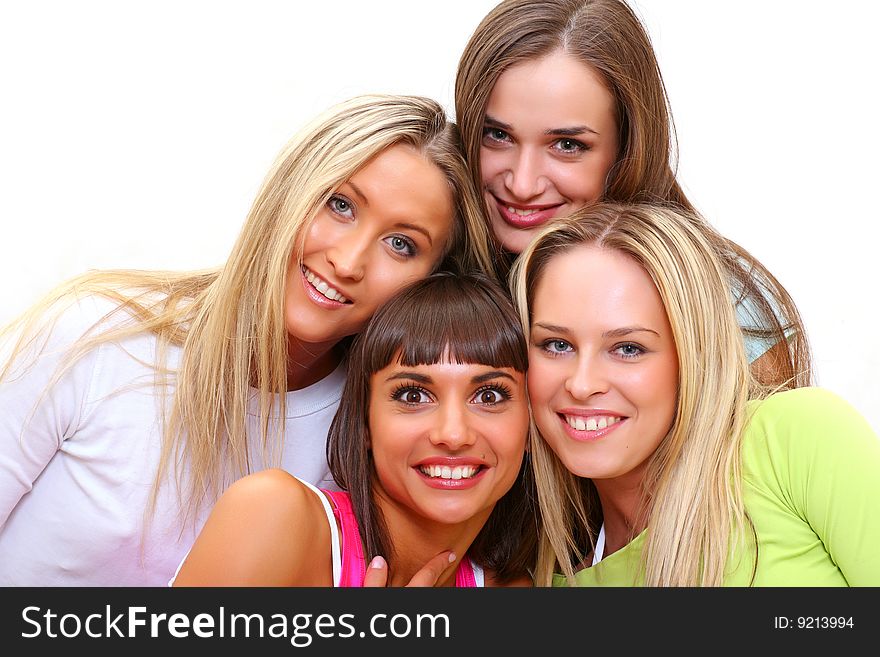 Four beautiful happy young women with a smile in bright multi-coloured clothes. Four beautiful happy young women with a smile in bright multi-coloured clothes