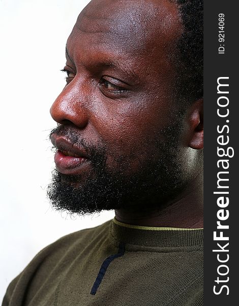 Portrait in a profile of the black man with a small beard close up. Portrait in a profile of the black man with a small beard close up