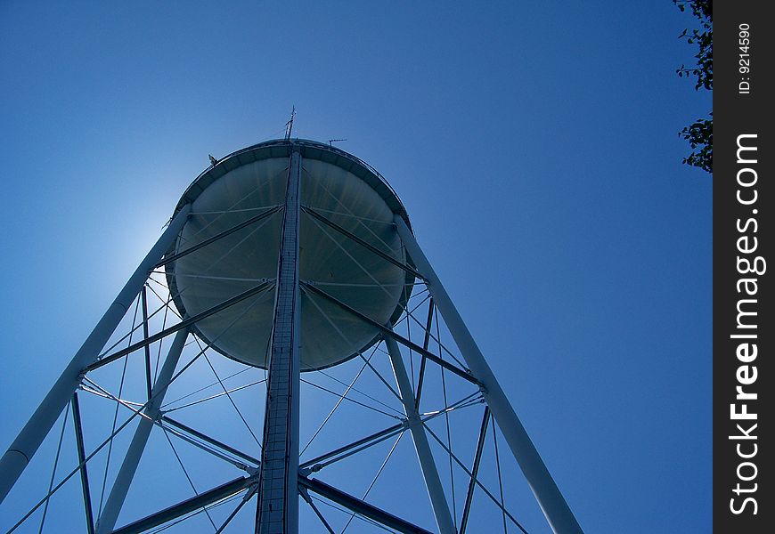 A blue water tower reaching for the sky. A blue water tower reaching for the sky
