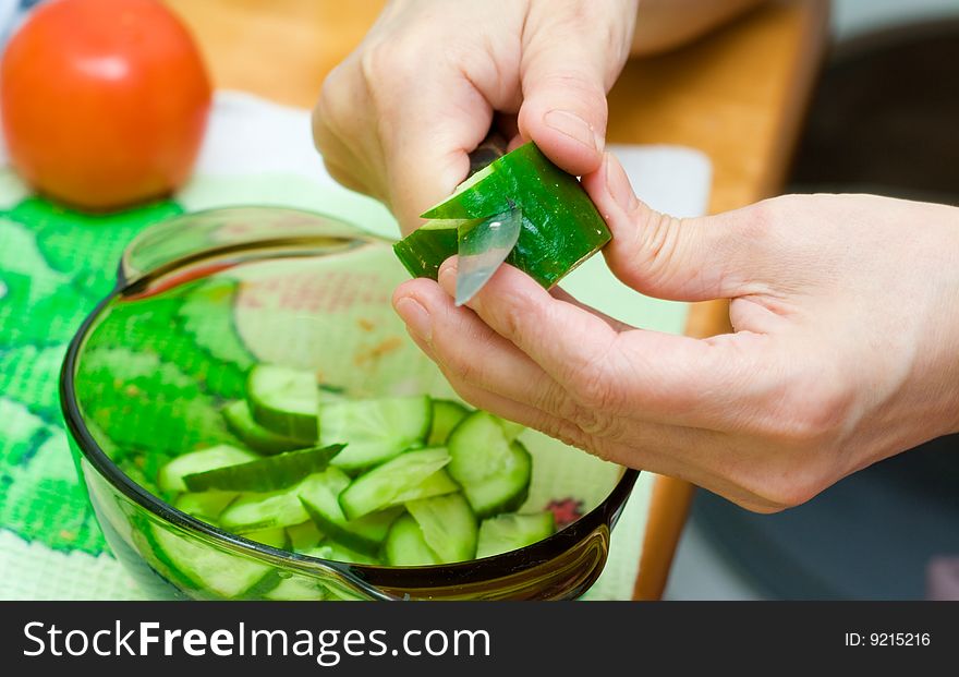 Woman cutting vegetables close up. Woman cutting vegetables close up