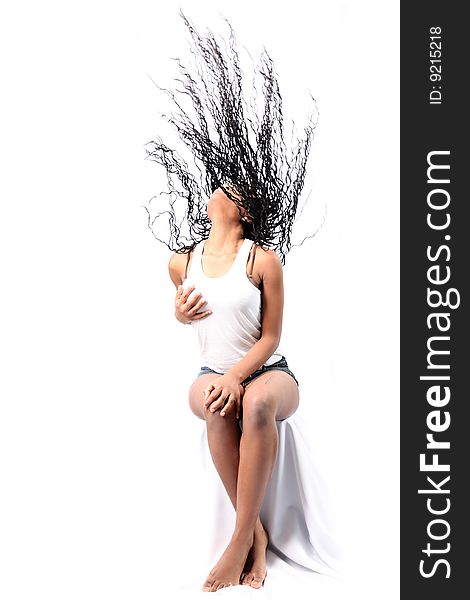 Wind - lovely young afro-american woman with long flapping hairs isolated on white