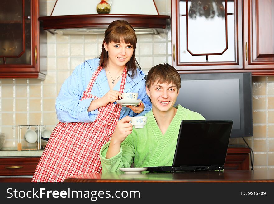 Happy young couple on a kitchen at home. Happy young couple on a kitchen at home.