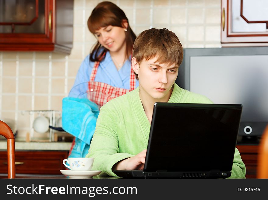 Happy young couple on a kitchen at home.