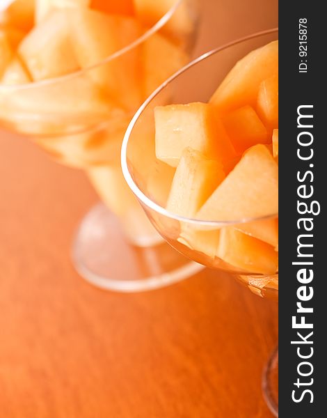 Cantaloupe cut and in parfait glass light background. Cantaloupe cut and in parfait glass light background