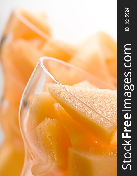 Cantaloupe cut and in parfait glass light background. Cantaloupe cut and in parfait glass light background