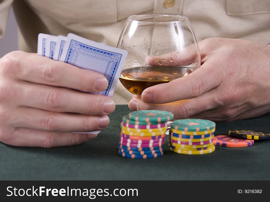 Glass with cognac and chips for a game in a casino. Glass with cognac and chips for a game in a casino