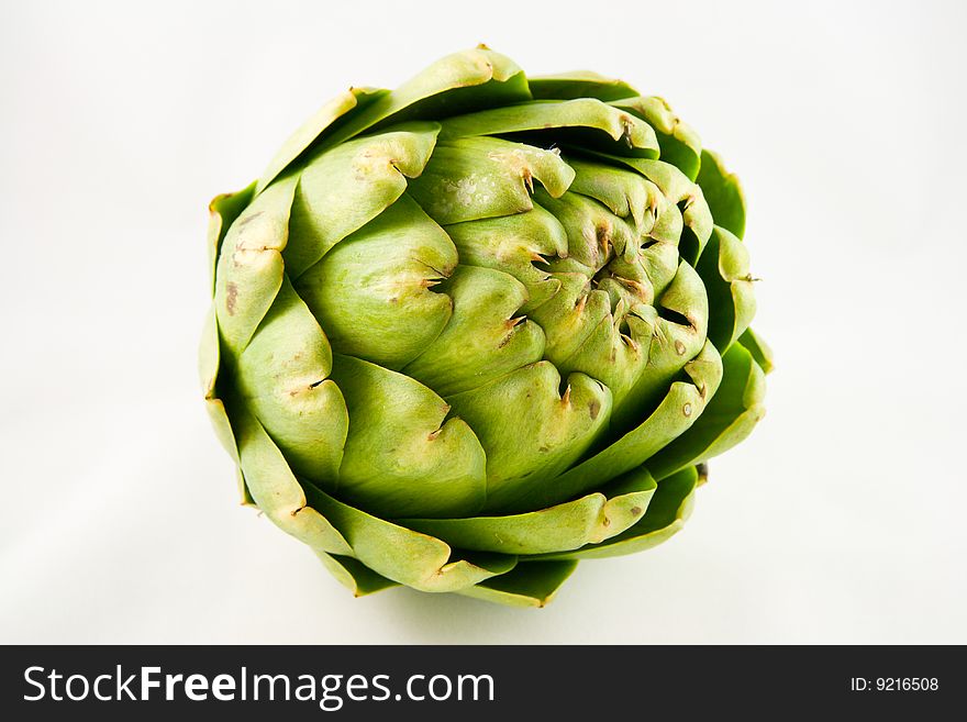 Single green artichoke on a white background. Single green artichoke on a white background