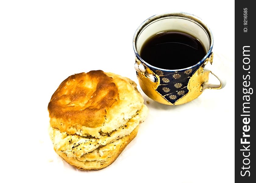 A decorative porcelain cup with coffee or tea and a grilled chicken biscuit for breakfast, snack or lunch. A decorative porcelain cup with coffee or tea and a grilled chicken biscuit for breakfast, snack or lunch.