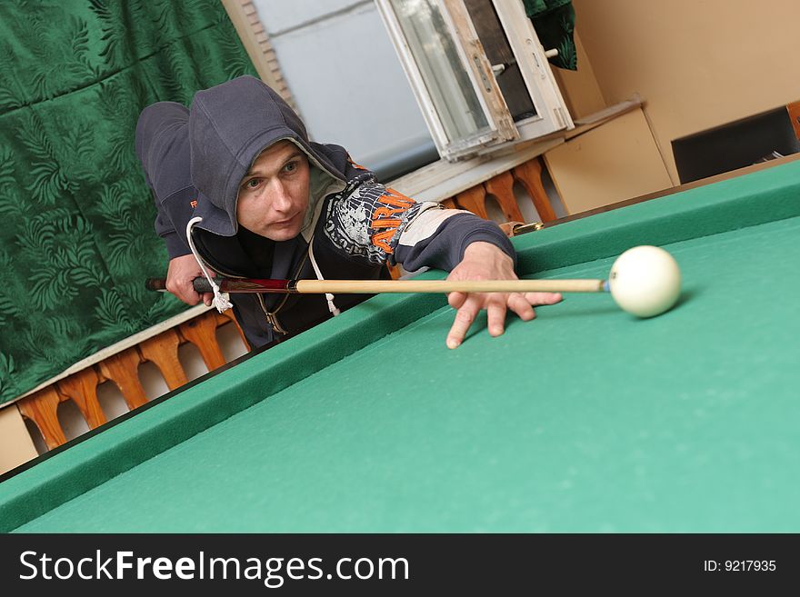 The mid adult man plays in billiards