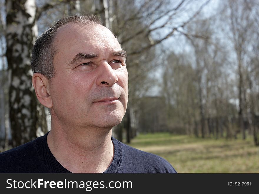 Portrait of mature man in a park. Portrait of mature man in a park