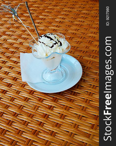 Beautiful ice-cream in glass with chocolate on a table. Beautiful ice-cream in glass with chocolate on a table.