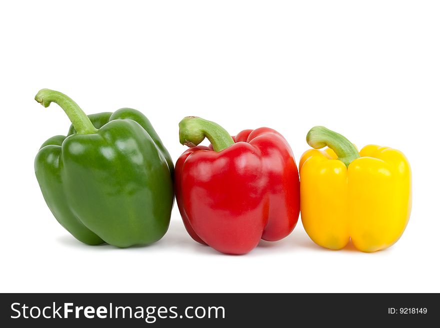 Green, yellow and red paprika, isolated on white background with shadow