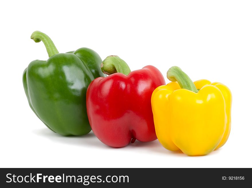 Green, yellow and red paprika, isolated on white background with shadow