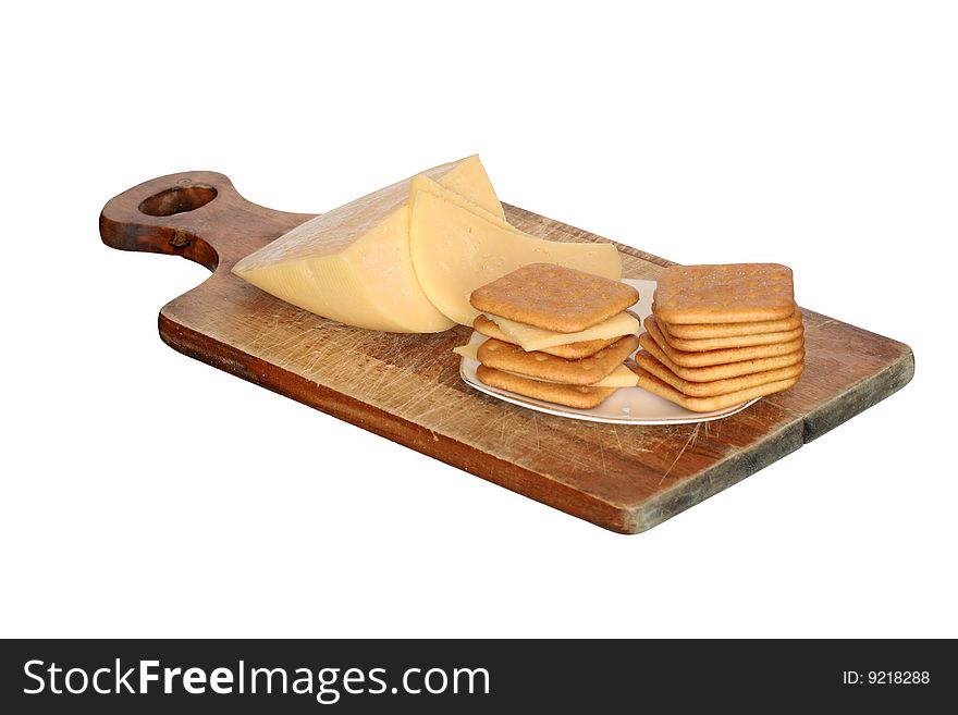 Crackers and cheese lying on breadboard isolated on white background. Crackers and cheese lying on breadboard isolated on white background