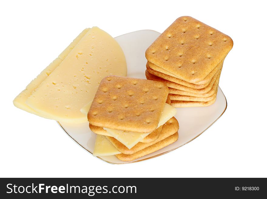 Stack of crackers and cheese lying on saucer isolated on white background with clipping path. Stack of crackers and cheese lying on saucer isolated on white background with clipping path