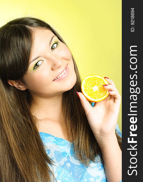 Portrait of pretty young brunette woman with an orange. Portrait of pretty young brunette woman with an orange