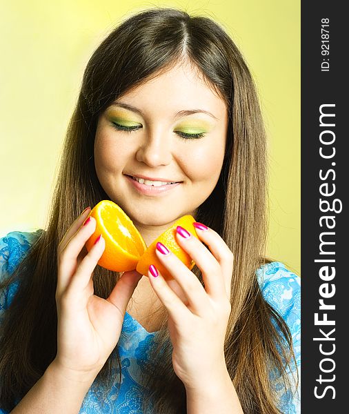 Portrait of pretty young brunette woman with an orange. Portrait of pretty young brunette woman with an orange