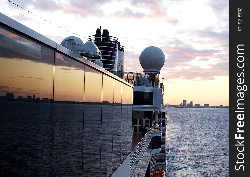 Cruise ship leaving port at sunset.