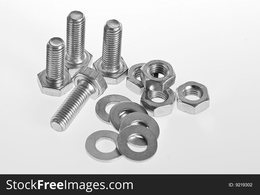 Bolts, screws and nuts on a white background. Bolts, screws and nuts on a white background