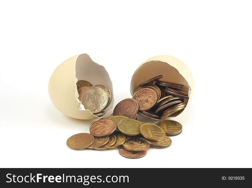 Coins in cracked egg. Close up. Coins in cracked egg. Close up