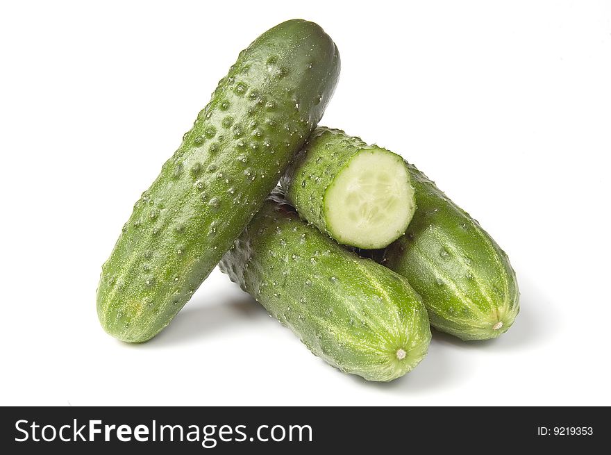 Four fresh cucumbers, isolated on white background