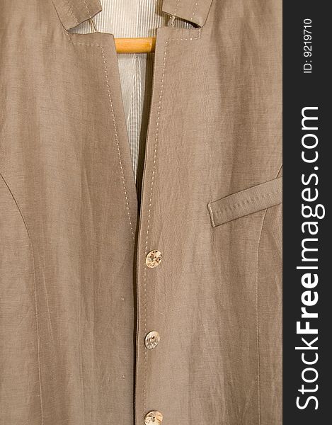 Partial view of  a  female fashionable brown linen  jacket. Partial view of  a  female fashionable brown linen  jacket