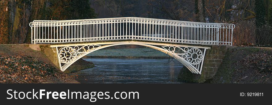 White iron bridge in a park