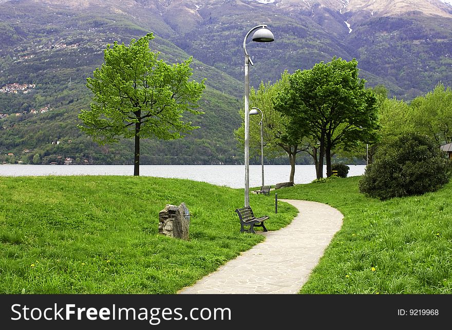 'driveway in the park with benches and lampposts