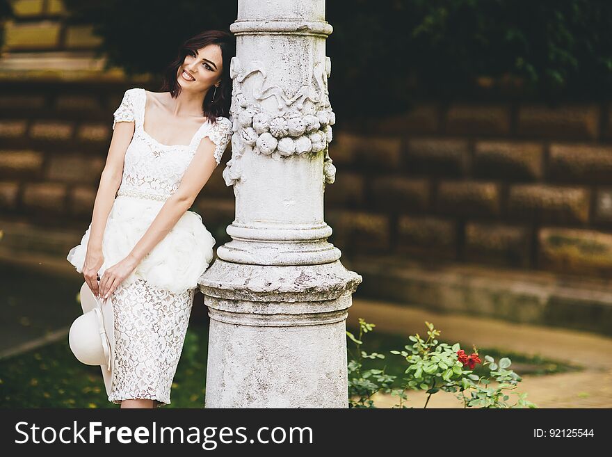 Young woman in white dress on the street