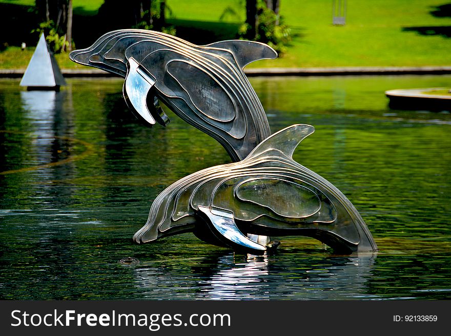 Gray and Brass Metal Dolphin Pool Decor