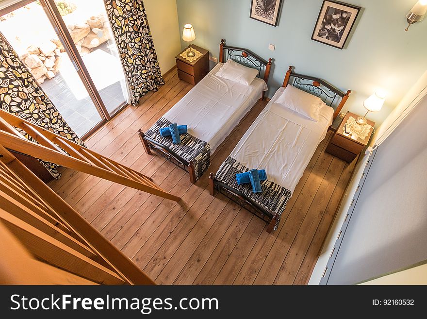 Elevated view of twin beds in modern rustic style bedroom. Elevated view of twin beds in modern rustic style bedroom.