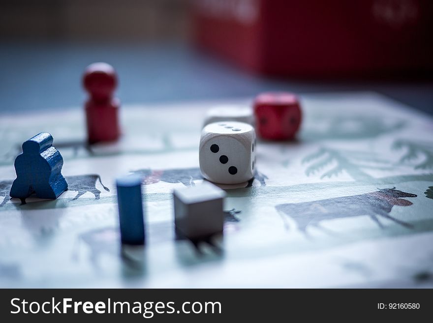 A board game with dice and pieces on a table.