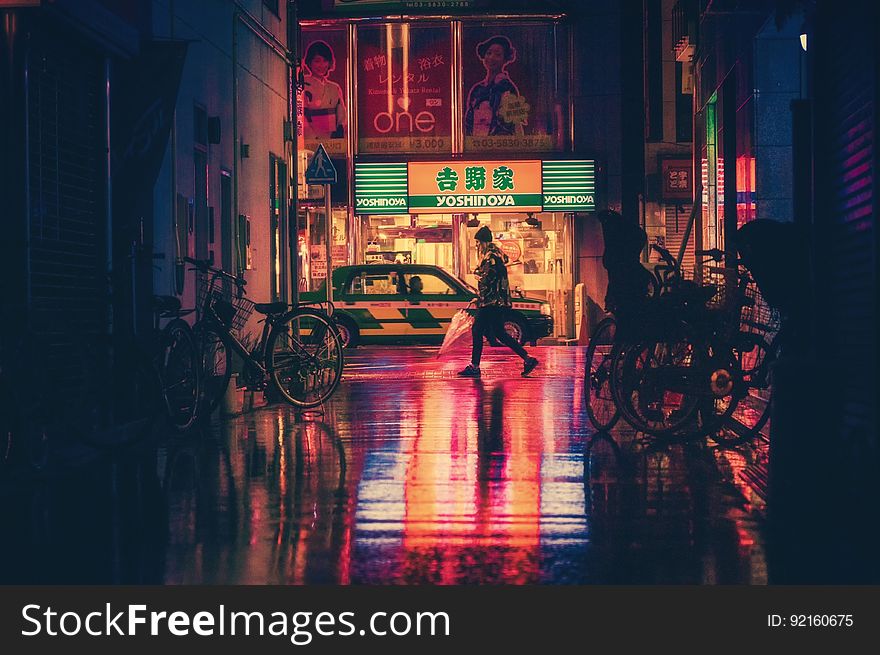 Side View Of Woman In Illuminated City At Night