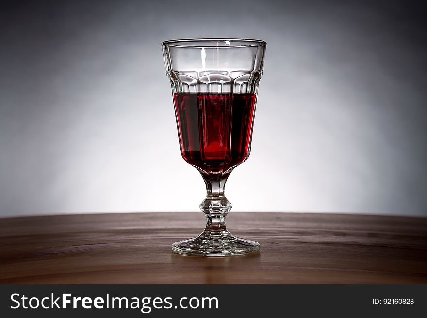A glass of wine or other red liquid.
