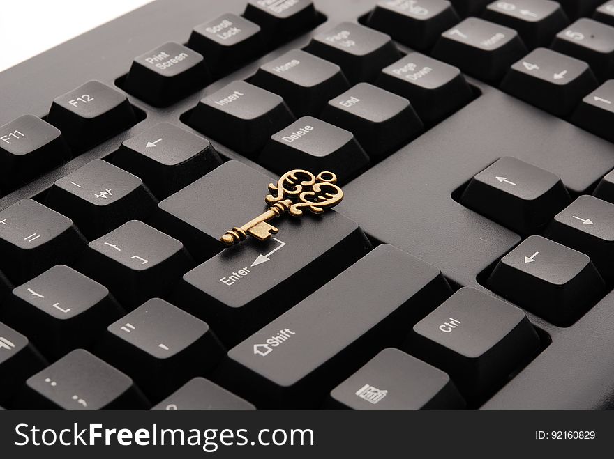 Brass Ornate Vintage Key on Black Computer Keyboard