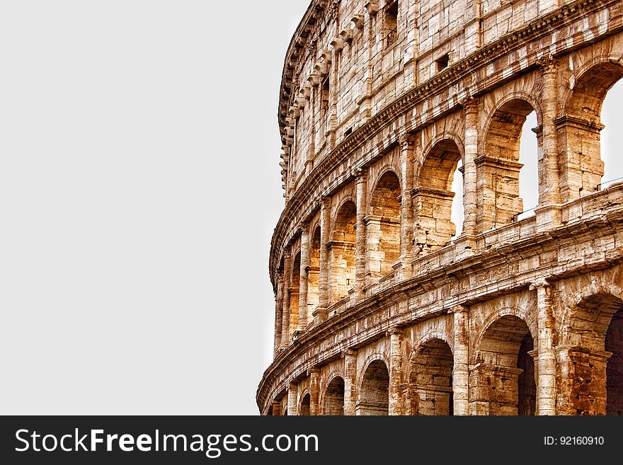 Partial exterior view of the Colosseum in Rome, Italy, isolated against a white background. Partial exterior view of the Colosseum in Rome, Italy, isolated against a white background.