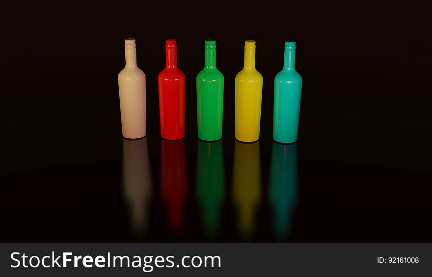 Colorful painted bottles lined up on black. Colorful painted bottles lined up on black.