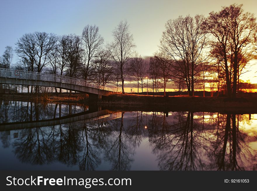 Bridge Over River At Sunset