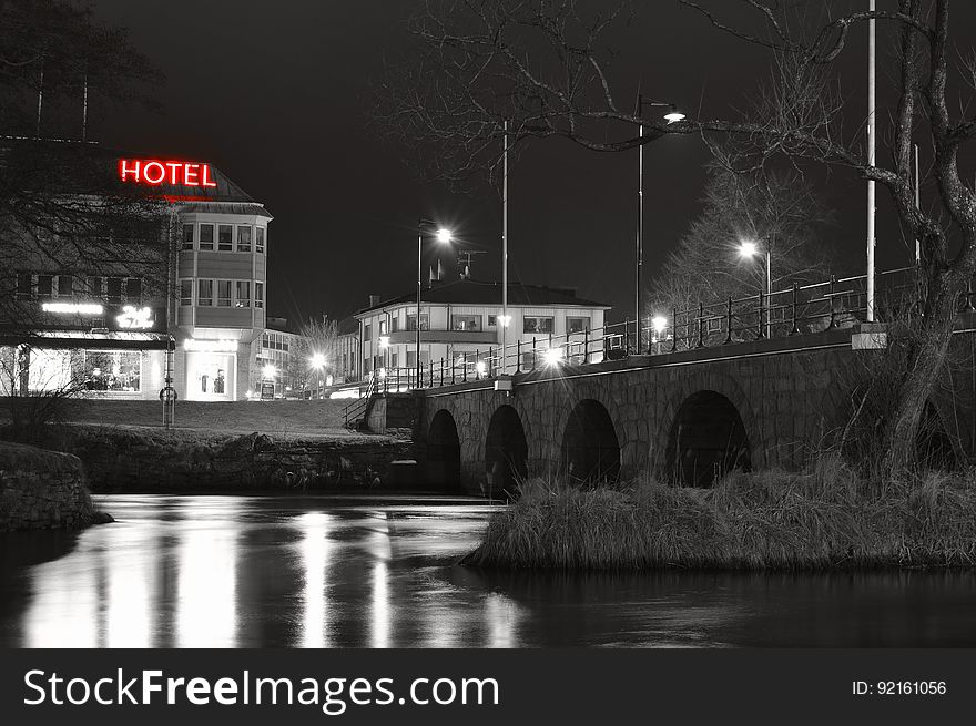 Lights from city hotel and buildings reflecting in waterfront at night. Lights from city hotel and buildings reflecting in waterfront at night.