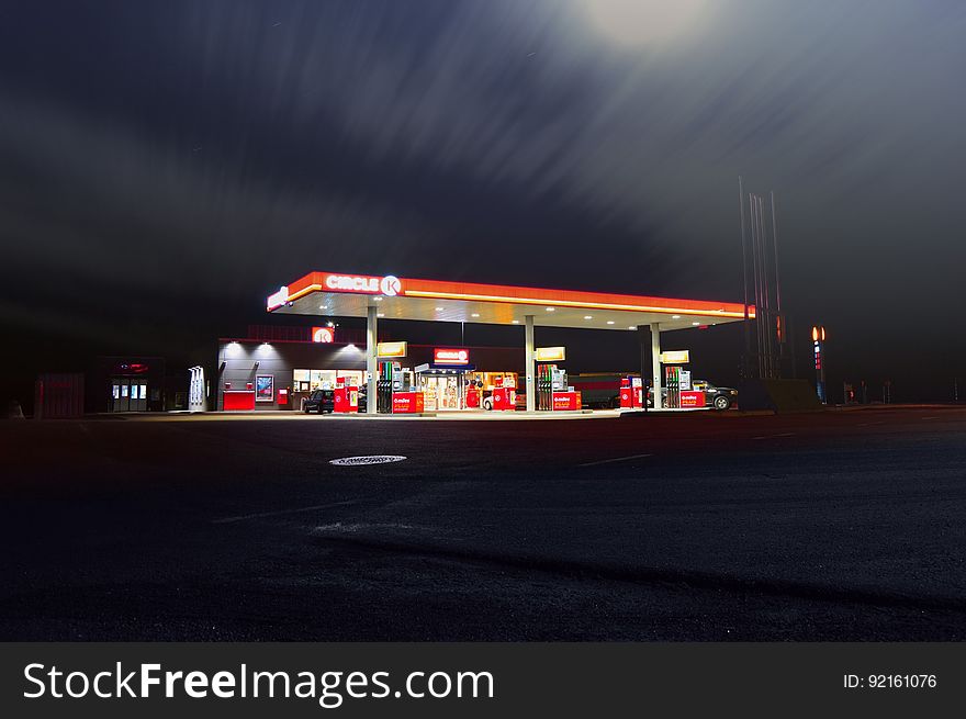 Exterior of modern gas station illuminated at night.
