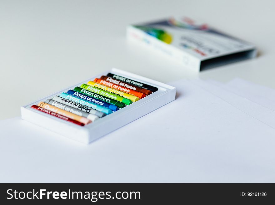 A box of color crayons in a box on white background.