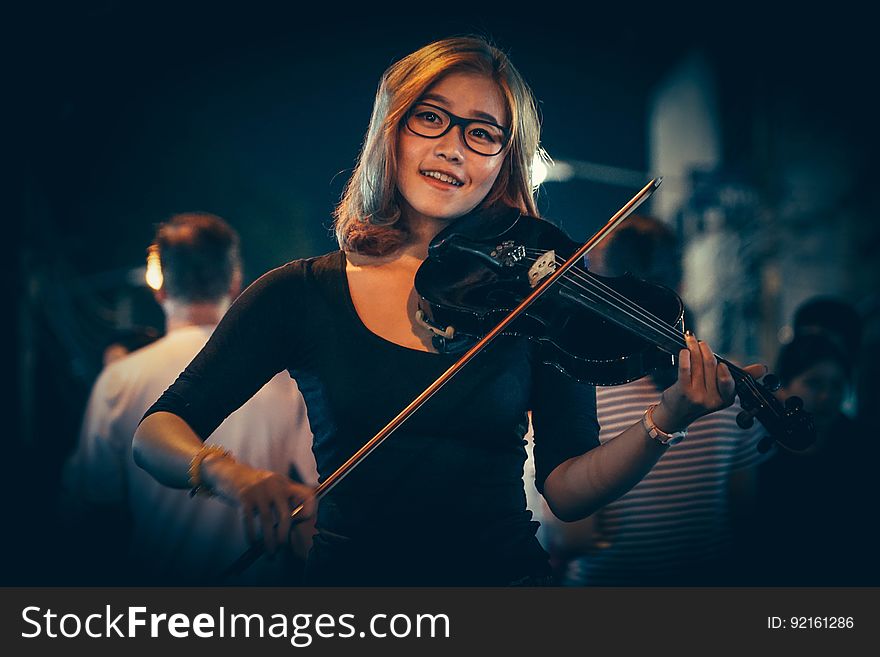 Portrait of smiling woman playing violin. Portrait of smiling woman playing violin.