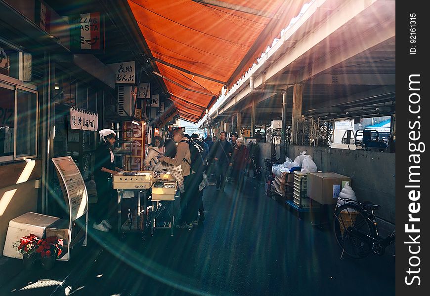 Sunlight over stalls inside covered market. Sunlight over stalls inside covered market.