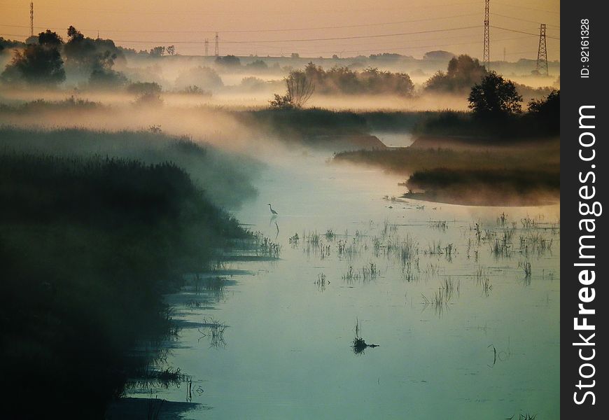 Mist over banks of river at sunrise. Mist over banks of river at sunrise.