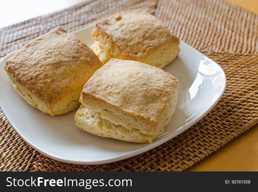 A plate of bread or other baked goods on a table.