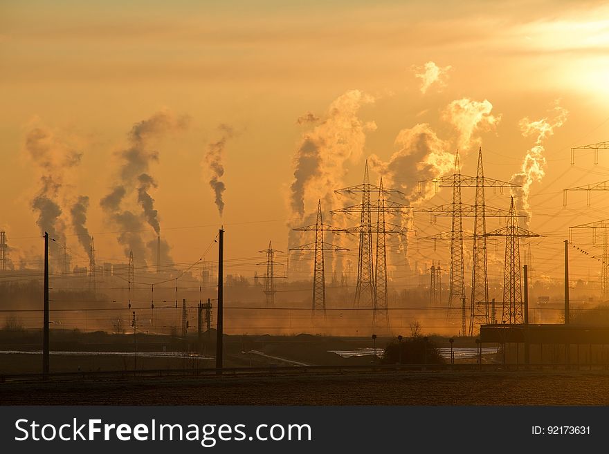 Polluting Smokestacks At Sunset