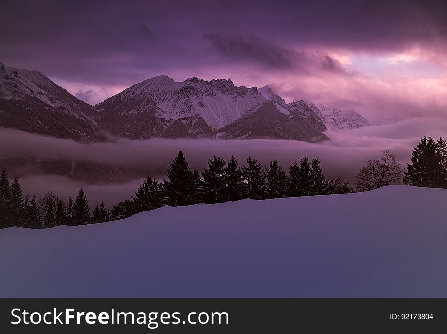 Scenic View Of Lake Against Dramatic Sky At Sunset