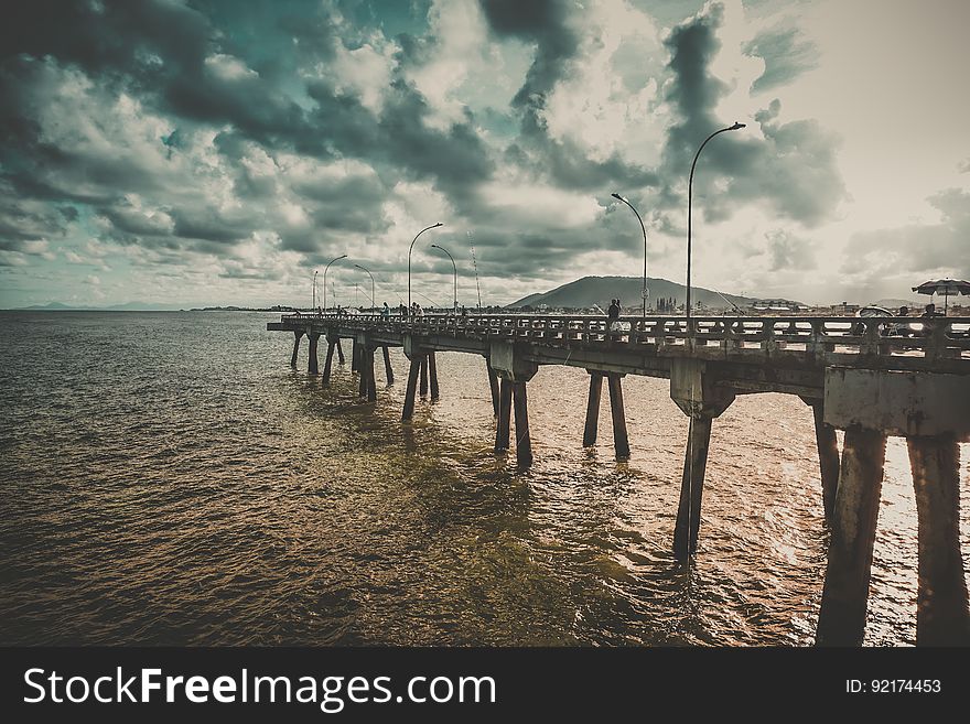 A long jetty extending into the distance on the coast of the sea. A long jetty extending into the distance on the coast of the sea.