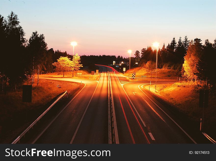 A long exposure of a highway with light trails of the traffic. A long exposure of a highway with light trails of the traffic.