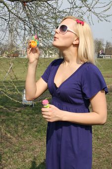 Girl Blowing Soap Bubbles Royalty Free Stock Images